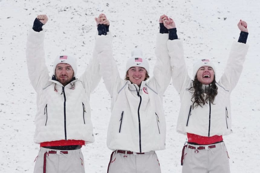 (De Izq. a Der.) Los medallistas de oro estadounidenses Christopher Lillis, Connor Curran y Kaila Kuhn celebran después de la final de esquí acrobático por equipos mixtos en los Juegos Olímpicos de Invierno de 2026, en Livigno, Italia, el 21 de febrero de 2026. (Gregory Bull/AP Photo)