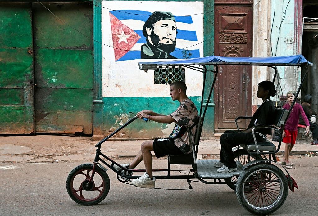 Un bicitaxi circula por una calle de La Habana, el 13 de febrero de 2026. La crisis del combustible en Cuba, y en particular en La Habana, está obligando a muchos trabajadores que dependen del transporte diario a abandonar los coches de gasolina. (Foto de YAMIL LAGE / AFP vía Getty Images)