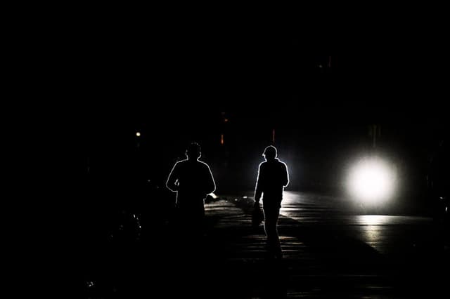 Unas personas caminan por una calle durante un apagón en La Habana el 25 de enero de 2026. (YAMIL LAGE / AFP vía Getty Images)