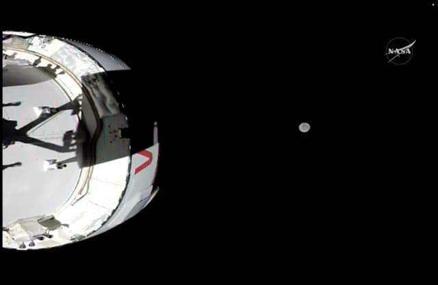 La nave espacial Orión, llamada Integrity, fue captada por una cámara montada en uno de sus paneles solares mientras volaba hacia la Luna, que se ve al fondo, el 4 de abril de 2026. (Captura de pantalla/NASA)