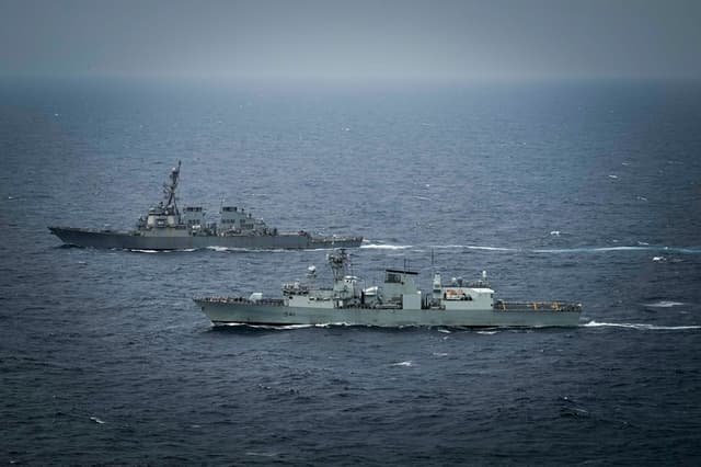 El destructor lanzamisiles USS Higgins (DDG 76) y el HMCS Ottawa (FFH 341) de la Marina Real Canadiense maniobran en aguas internacionales durante el ejercicio "Noble Wolverine" en el mar de la China Meridional el 11 de enero de 2025. (Armada de Estados Unidos, cortesía de la Marina Real Canadiense, por el marinero de tercera clase Jacob Saunders)