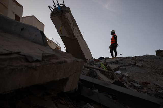 Un integrante de un equipo de rescate camina sobre escombros de un edificio este lunes, en La Guaira. Los trabajos de rescatistas nacionales y extranjeros continúan, principalmente, entre las ruinas de edificaciones del estado costero de La Guaira (aledaño a Caracas), la zona cero de la devastación por los sismos de magnitud 7.2 y 7.5 del pasado miércoles y donde están instalados centros logísticos de los equipos internacionales. (EFE/ Ronald Peña R)