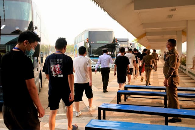 Presuntos trabajadores y víctimas de centros fraudulentos procedentes de China llegan al puesto fronterizo con Tailandia en el este del municipio de Myawaddy, Birmania, el 20 de febrero de 2025. (STR/AFP vía Getty Images).