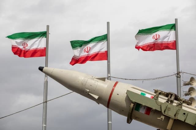 Misiles fabricados por las fuerzas armadas de Irán se exhiben junto a una hilera de banderas iraníes durante las conmemoraciones del aniversario de la Revolución Iraní de 1979 en Teherán, Irán, el 11 de febrero de 2026. (Majid Saeedi/Getty Images)