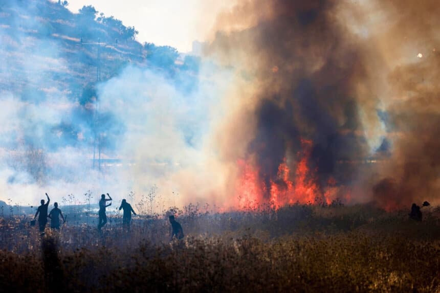 Palestinos intentan extinguir un incendio presuntamente provocado por colonos israelíes en campos de trigo en la aldea de Salem, al este de Nablus, en la Cisjordania ocupada, el 3 de julio de 2026. (Jaafar Ashtiyeh / AFP vía Getty Images).