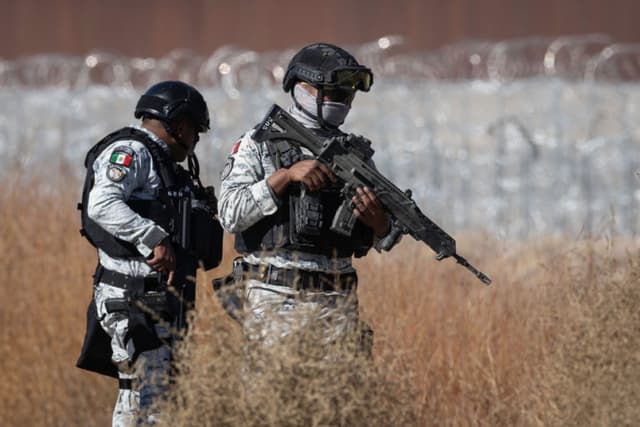 Soldados de la Guardia Nacional de México buscan escaleras utilizadas por traficantes e inmigrantes para cruzar la cerca fronteriza entre México y Estados Unidos el 6 de febrero de 2025 cerca de Ciudad Juárez, México. (John Moore/Getty Images)