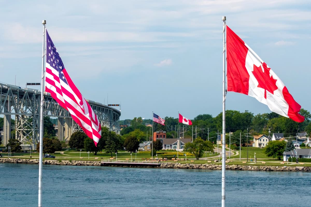 Banderas canadienses y estadounidenses ondean a ambos lados del río St. Clair cerca del puente Blue Water, que conecta Sarnia, Ontario, y Port Huron, Michigan, en Sarnia, Ontario, Canadá, el 2 de septiembre de 2026. (Carlos Osorio/Reuters).