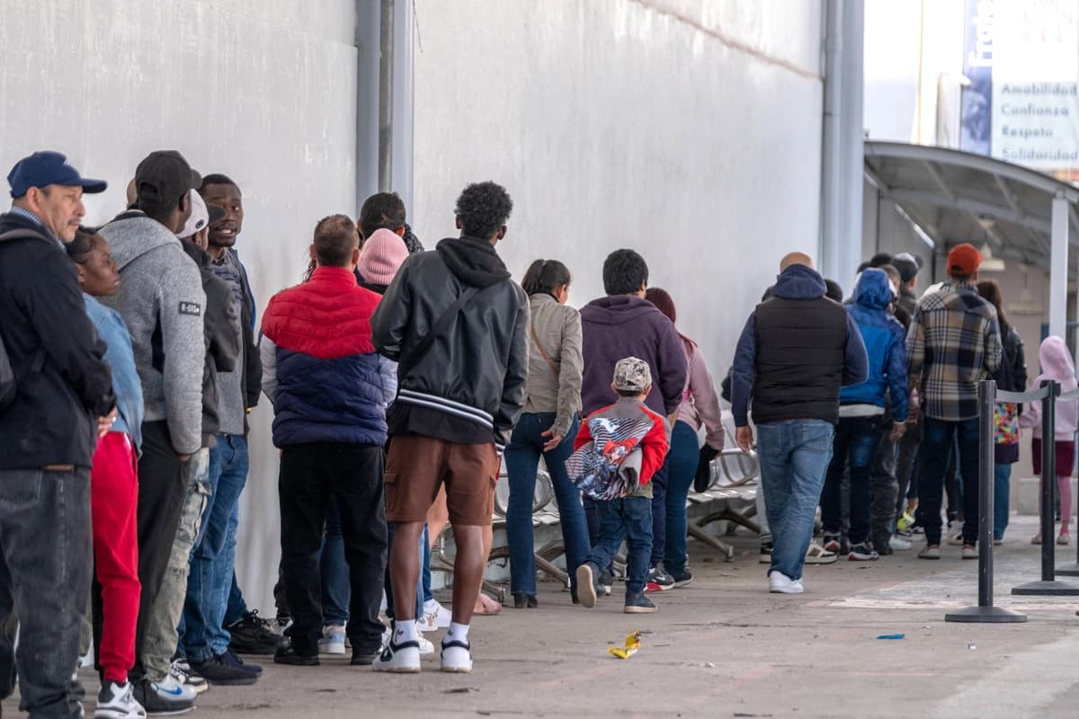 Solicitantes de asilo hacen fila en la entrada de las oficinas de la Comisión de Ayuda a los Refugiados de México y del ACNUR en Tijuana, Baja California, México, el 24 de enero de 2025. (Foto de Guillermo Arias / AFP vía Getty Images).