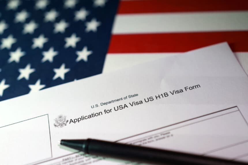 Una bandera de Estados Unidos y un formulario de solicitud de visa H-1B, en esta ilustración tomada el 22 de septiembre de 2025. (Dado Ruvic/Ilustración/Reuters).
