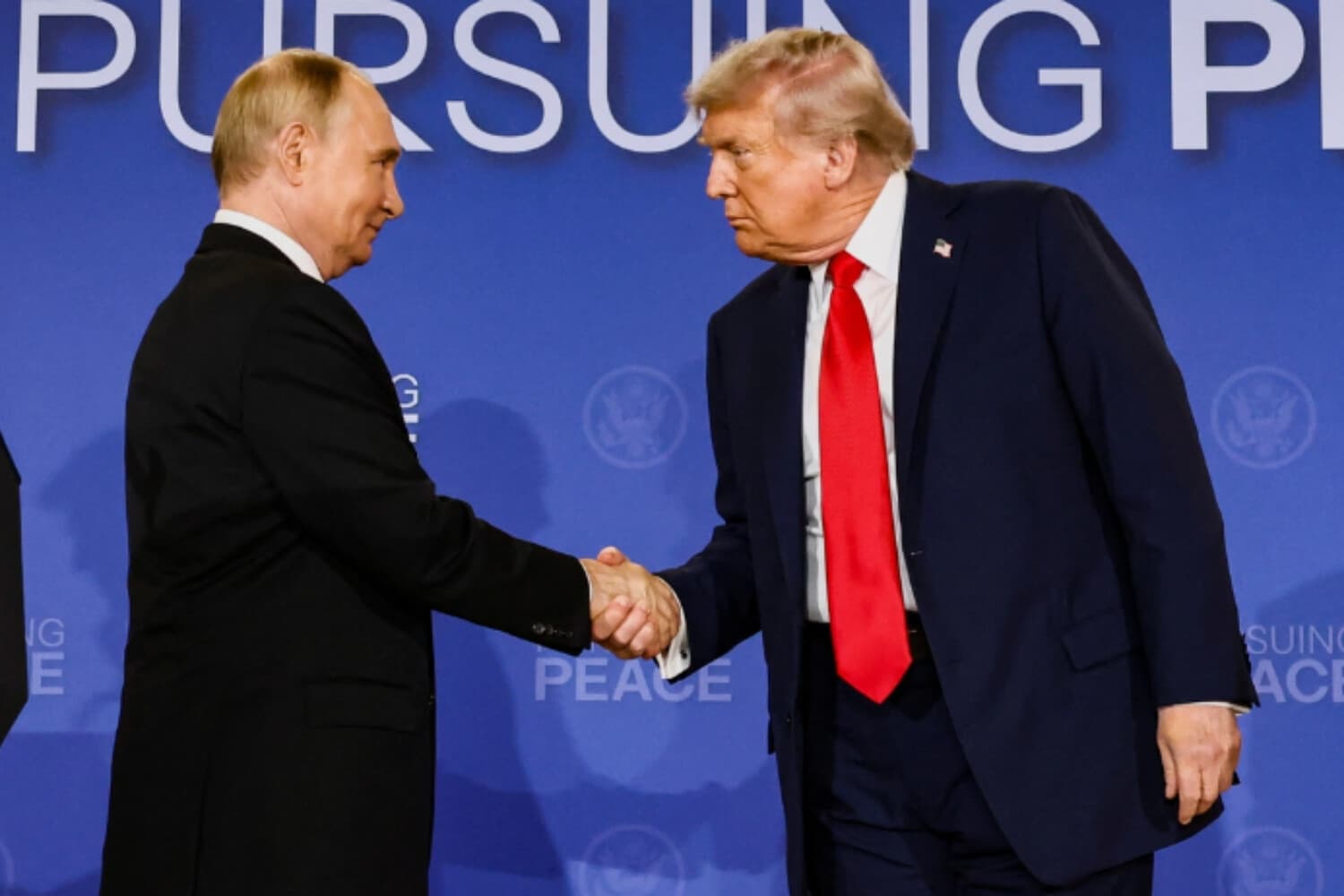El presidente de EE. UU., Donald Trump (derecha), y el presidente ruso, Vladímir Putin, se estrechan la mano durante una conferencia de prensa tras reunirse para negociar el fin de la guerra en Ucrania, en la Base Conjunta Elmendorf-Richardson, en Anchorage (Alaska), el 15 de agosto de 2025. (Kevin Lamarque/Reuters).